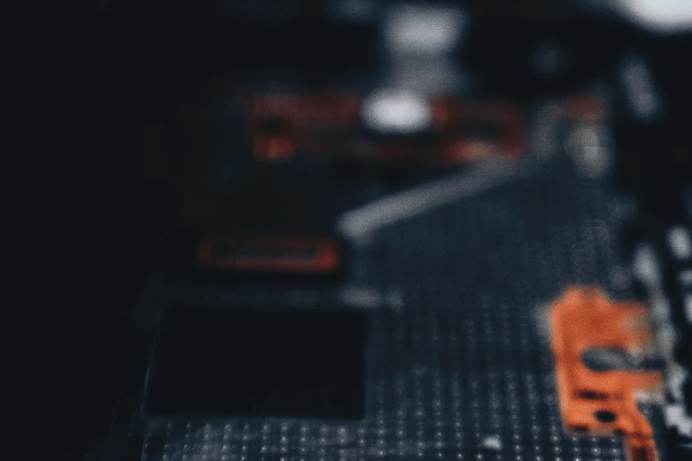 Close-up photograph of a dark circuit board with electronic components